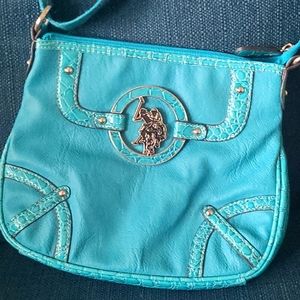 US Polo Association Turquoise crossbody purse with adjustable cloth strap.